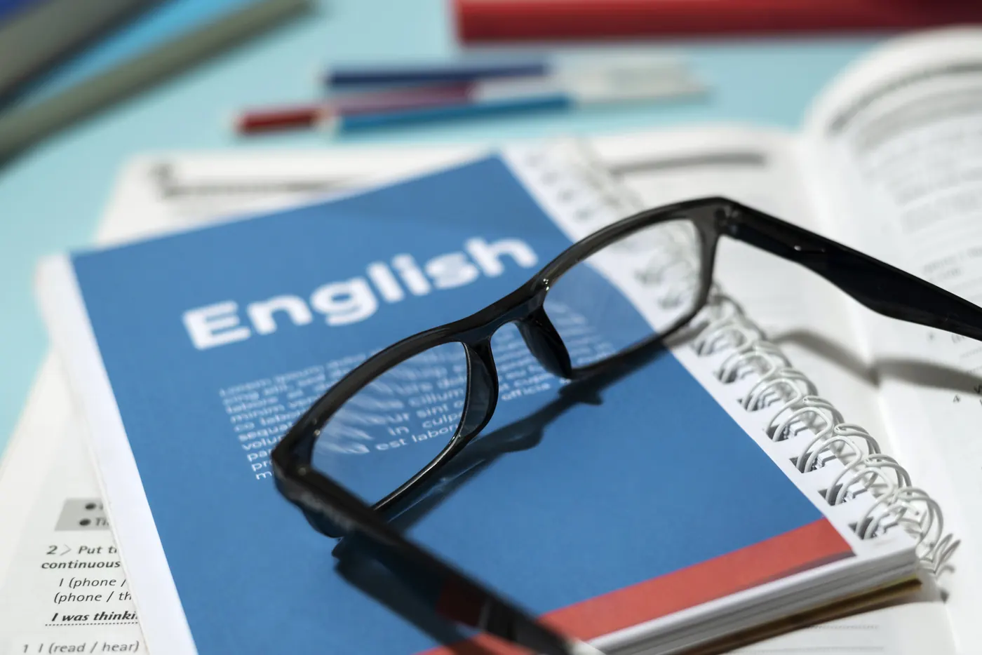 English book and glasses on a table